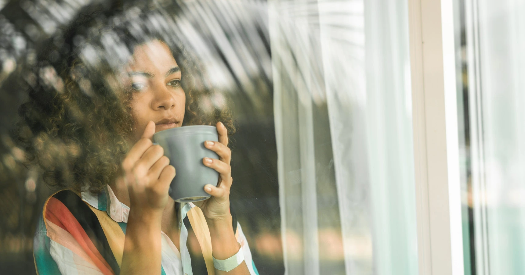 Emaar South - Fairway Villas 2 - Woman Drinking Coffee by the Window